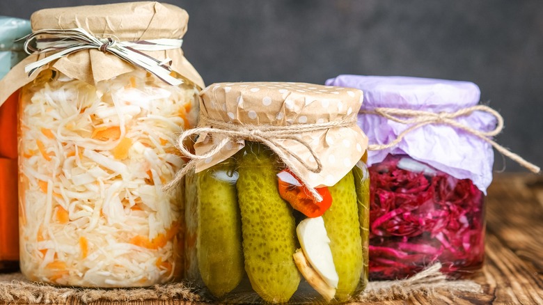 Jars of sauerkraut, red cabbage, and pickles