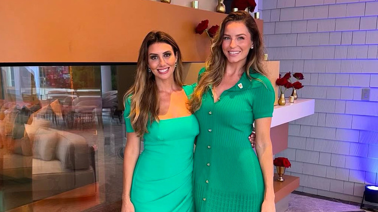 Alina Habba and Margo Martin posing in green dresses