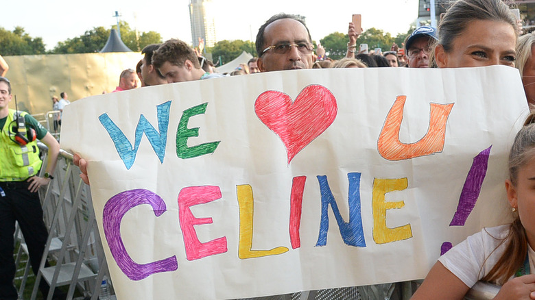 Fan holding up a sign