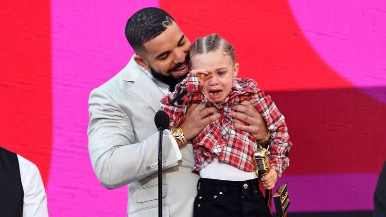 Drake and son Adonis at an event