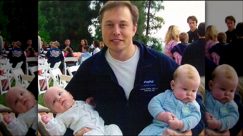 Elon Musk holding twins