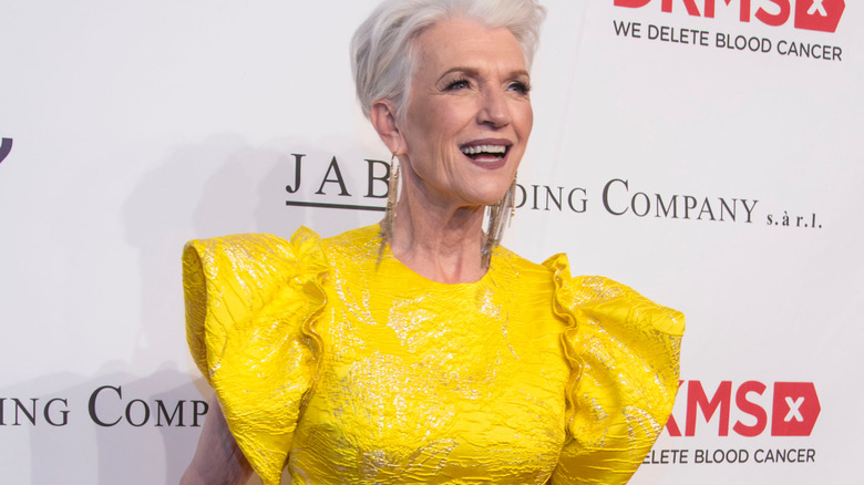 Maye Musk on red carpet, wearing yellow