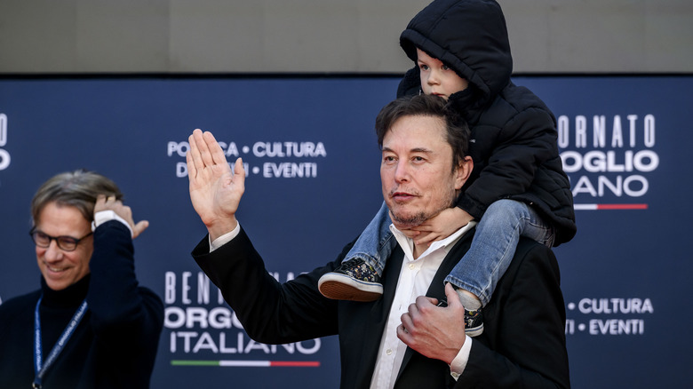 Elon Musk carrying his son on his shoulders