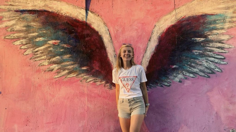 Gabby Petito smiling in front of mural 