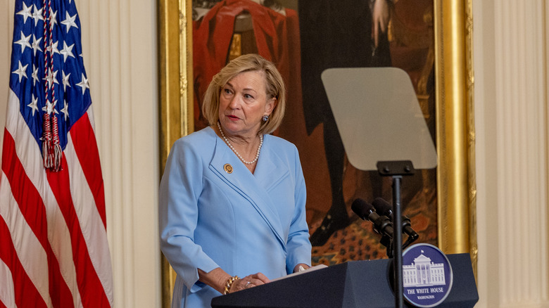 Susan Ford Bales giving speech at The White House in front of American flag