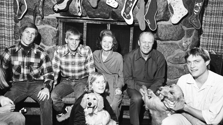 Gerald Ford with his wife and kids at Christmas sitting in front of fire place