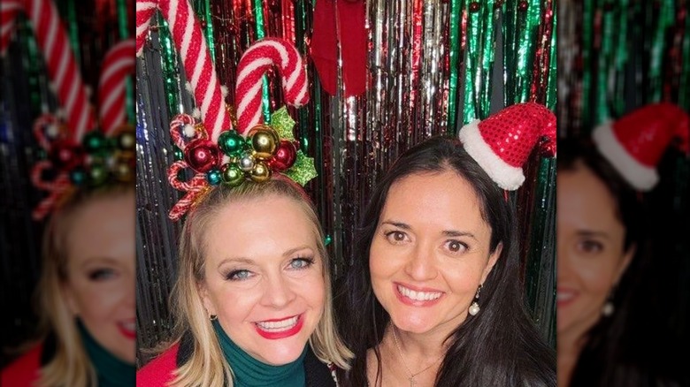 Melissa Joan Hart and Danica McKellar smiling with silly Christmas hats