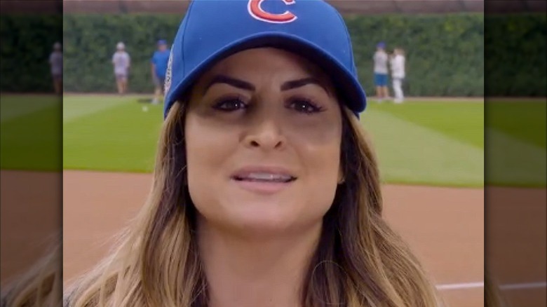 Alison Victoria speaking in Cubs baseball cap