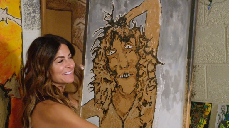 Alison Victoria smiling at a painting on "Ugliest House in America"