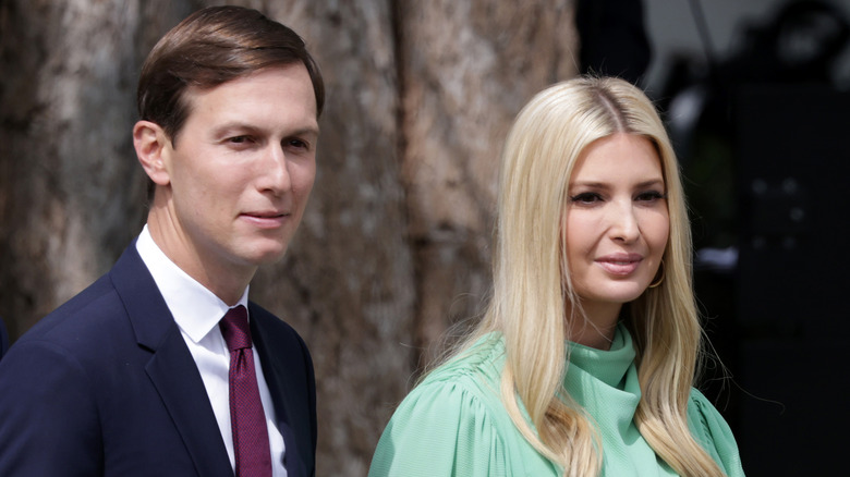 Jared Kushner and Ivanka Trump in green dress on White House lawn 