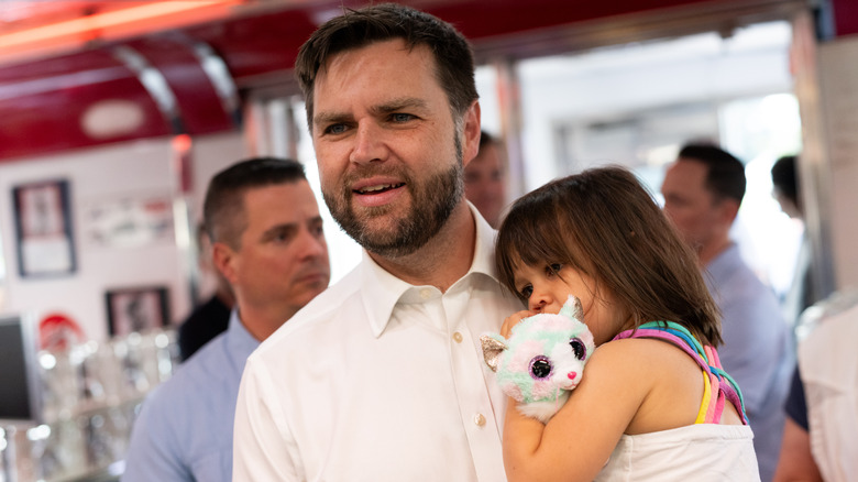 JD Vance carrying his daughter Mirabel