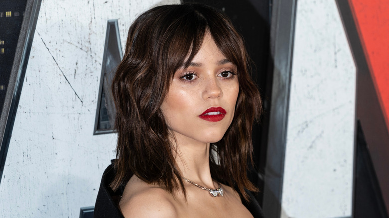 Jenna Ortega wearing red lipstick at a film premiere