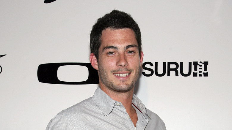 Brian Hallisay smiling on a step and repeat