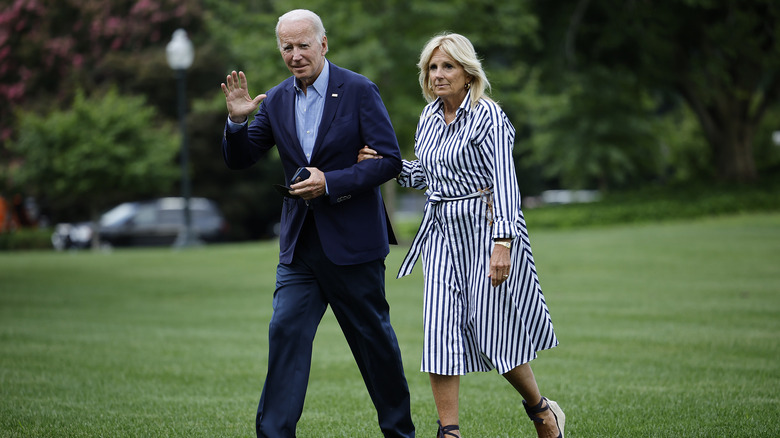 Joe and Jill Biden walking by White House