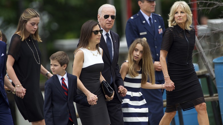 Robert Biden II and his family looking somber for Beau Biden's funeral 