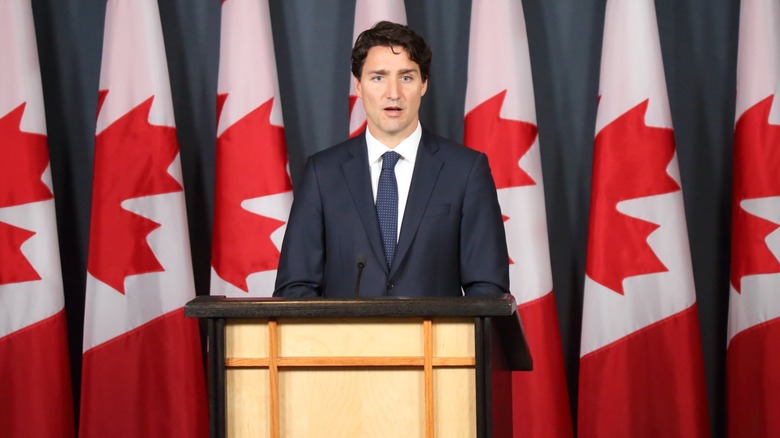 Justin Trudeau at podium with Canadian flags