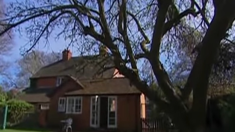 Middleton family home and bare tree in yard