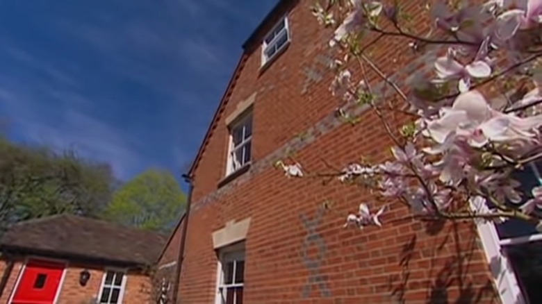 Exterior of Middleton family home with flowering dogwood