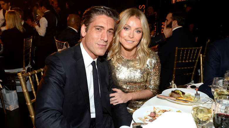 David Muir and Kelly Ripa smiling at the 6th Annual Save the Children Illumination Gala at the American Museum of Natural History in November 2018 in New York City