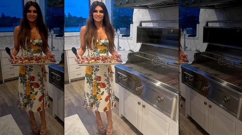 Kimberly Guilfoyle holding plate of food in kitchen