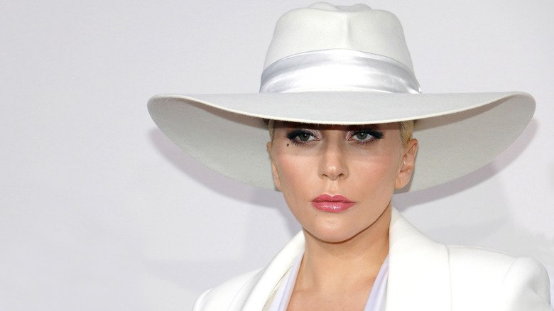 Lady Gaga posing in a white hat