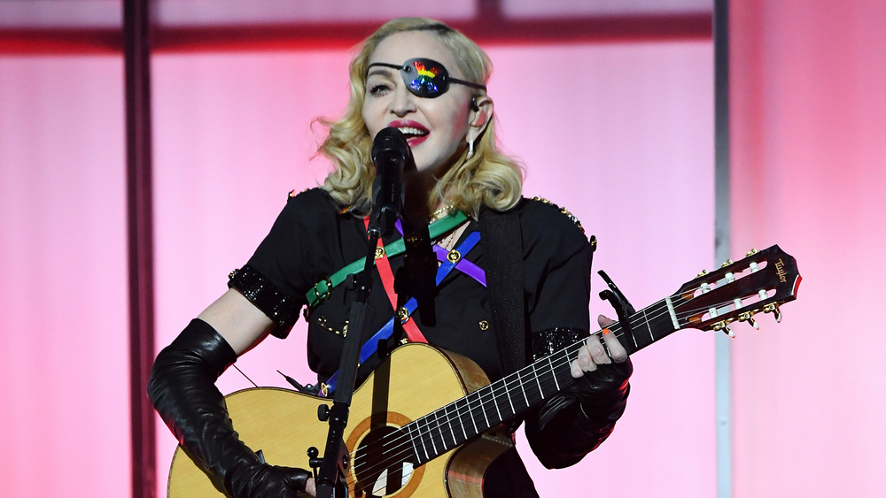 Madonna performing with guitar