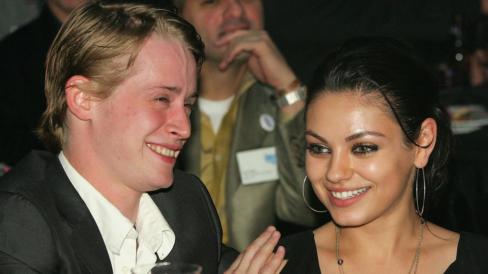 Mila Kunis and Macaulay Culkin smile together