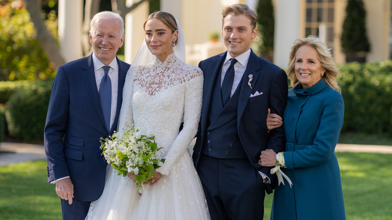 President Joe Biden, Naomi Biden, Peter Neal, and Jill Biden smiling