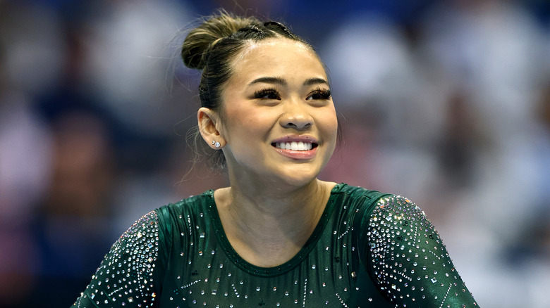 Suni Lee smiling during a competition in 2024