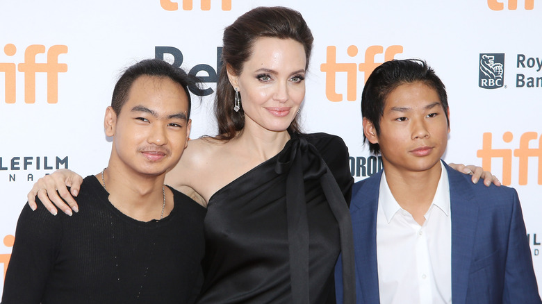 Angelina Jolie, Pax and Maddox Jolie-Pitt posing for photos