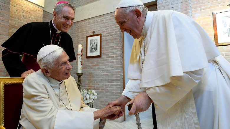 Pope Benedict XVI greets Pope Francis