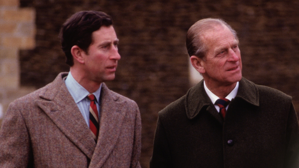 Prince Charles and Prince Philip looking into the distance.