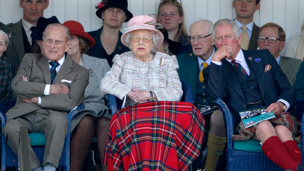 The queen, her husband, and son sitting together.