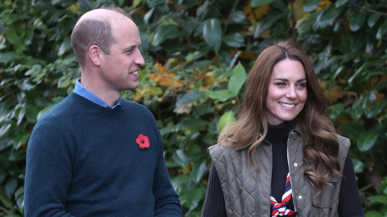 Prince William and Kate Middleton smiling outside for Remembrance Day