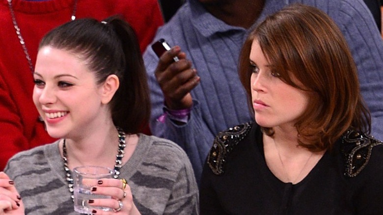 Michelle Trachtenberg and Princess Eugenie watch a basketball game