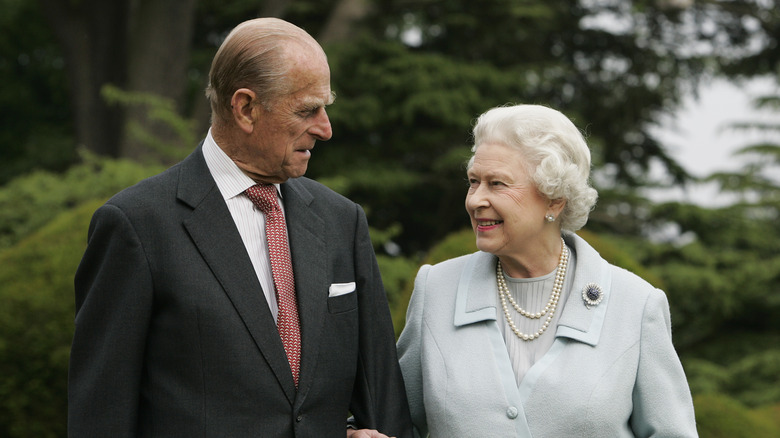 Queen Elizabeth and Prince Philip looking at each other