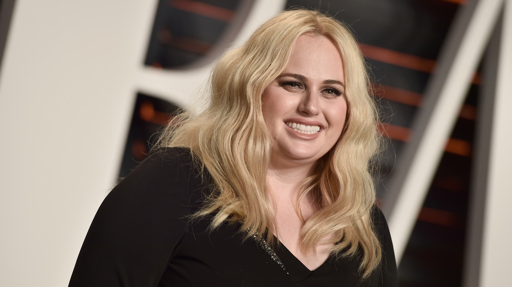 Rebel Wilson smiles at an event