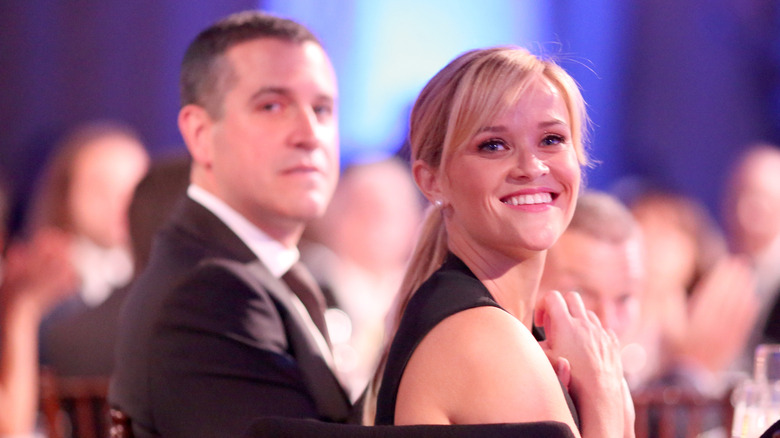 Reese Witherspoon smiling with Jim Toth at an event