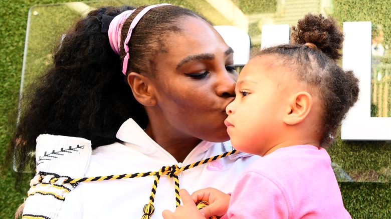 Serena Williams giving her daughter Alexis a kiss 