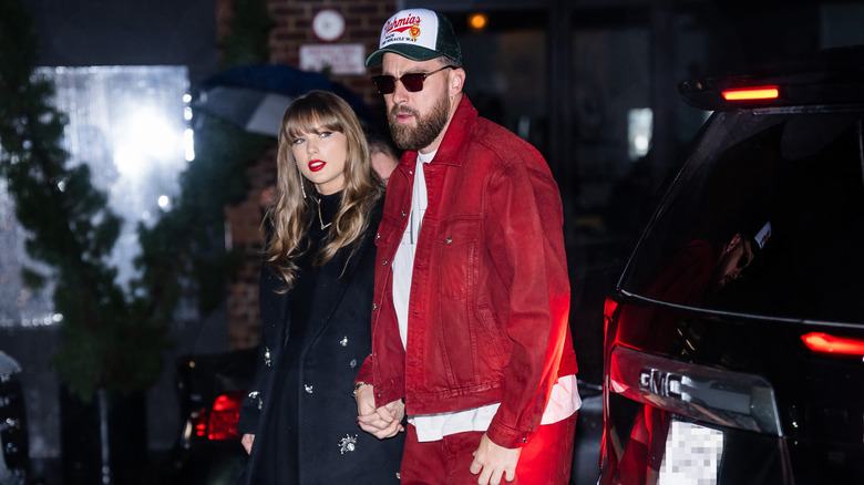 Taylor Swift holding hands with Travis Kelce