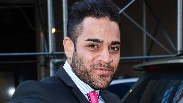 Mike Shouhed smiling in suit outside of Soho Hotel 