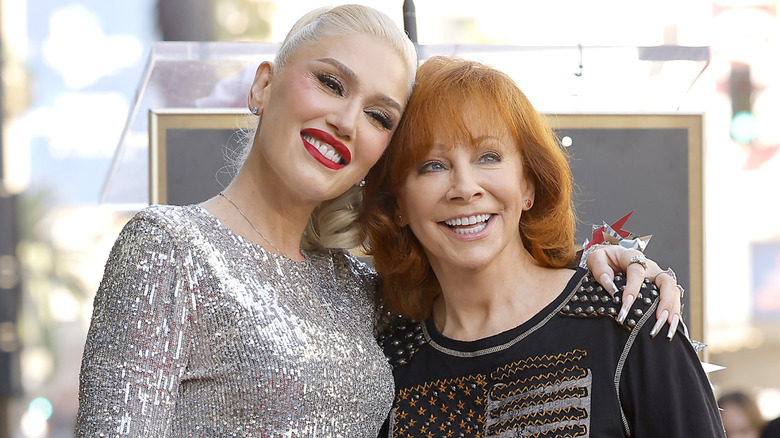 Reba McEntire embracing Gwen Stefani at Stefani's Hollywood Walk of Fame Ceremony