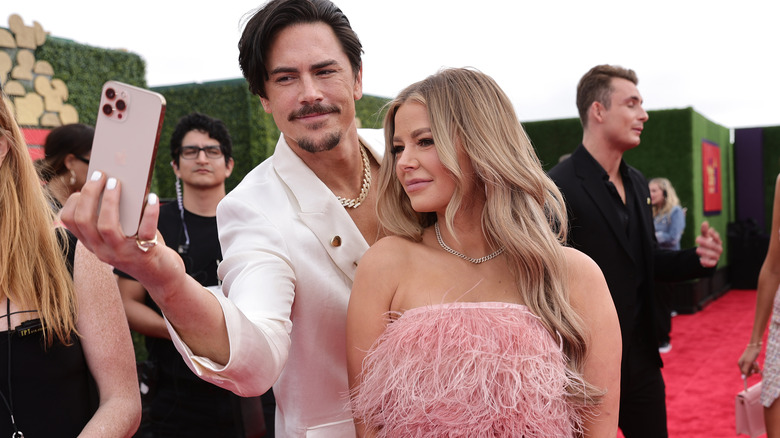 Ariana Madix and Tom Sandoval taking selfie on red carpet