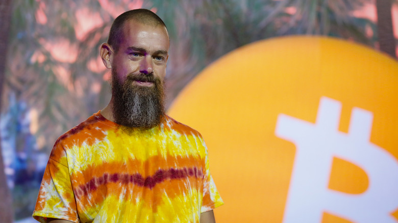 Dorsey in front of a bitcoin logo