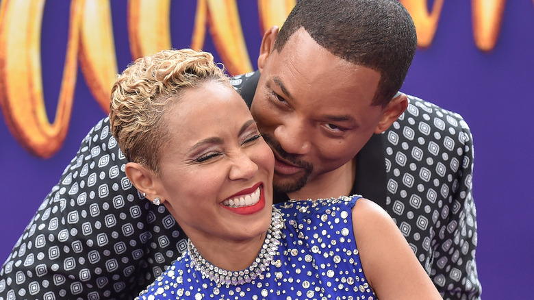 Will Smith and Jada Pinkett Smith cuddling close at a premiere