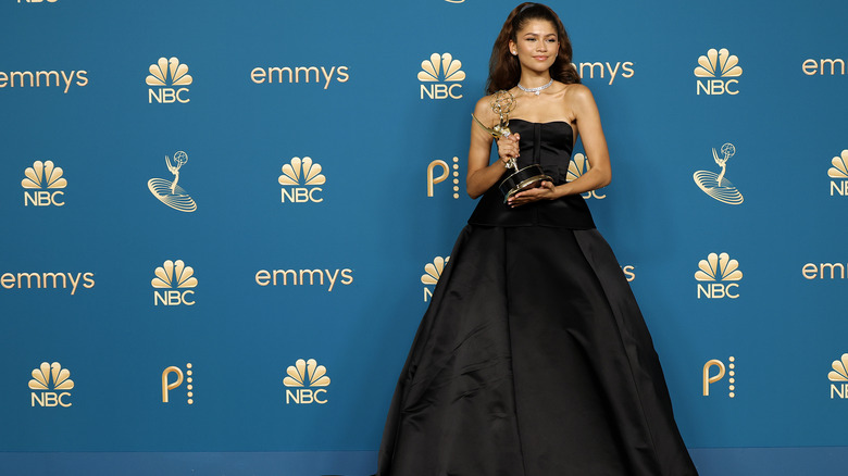 Zendaya posing with her Emmy statue