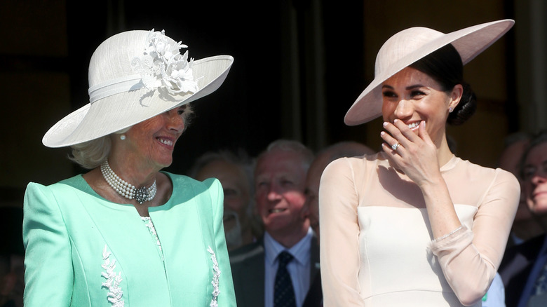 Queen Camilla and Meghan Markle laughing