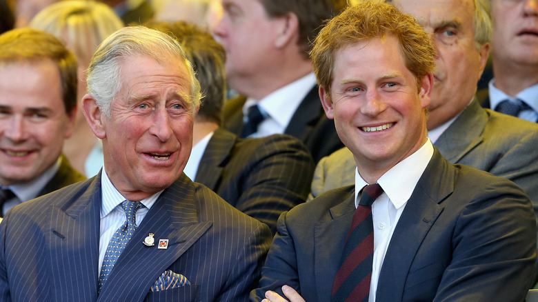 King Charles and Prince Harry smiling