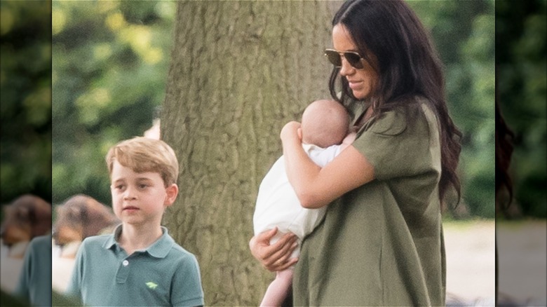 Meghan Markle holds Prince Archie in front of Prince George