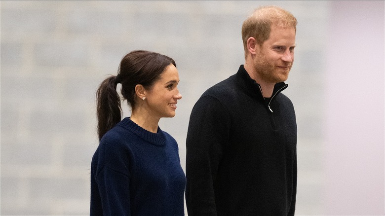 Prince Harry and Meghan Markle walking side-by-side at the 2025 Invictus Games in Vancouver, Canada